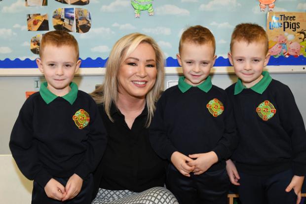 First Minister Michelle O’Neill pictured with triplets Jake, Jordan and Kyle.