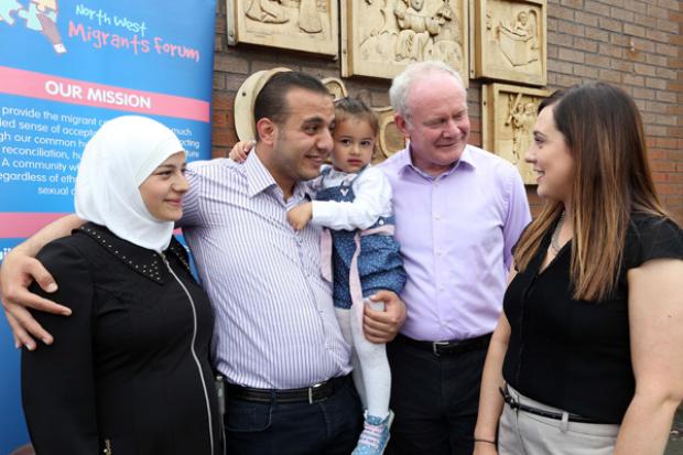 The deputy First Minister Martin McGuinness and Junior Minister Megan Fearon speaking to Mustafa Algadoaa, his wife Huda Khallo and daughter Yara (2) at a welcome reception in Derry.