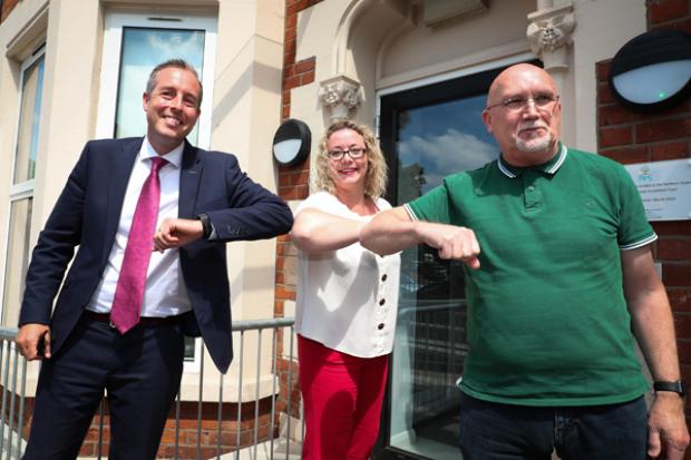 First Minister Paul Givan pictured with Renee Quinn and Rev Bill Shaw during a visit to PIPS Charity in North Belfast.