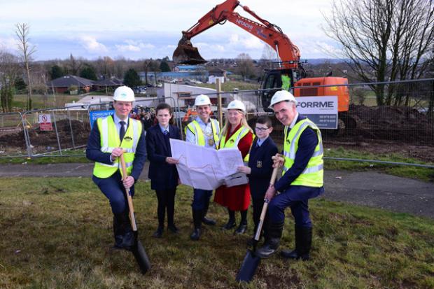 Junior Ministers Gordon Lyons (left) and Declan Kearney (right) with Lord Mayor Daniel Baker, St Colm's High School pupils Clodagh McCann and Ryan Flannery and Annie Armstrong of Colin Neighbourhood Partnership at the sod cutting ceremony.