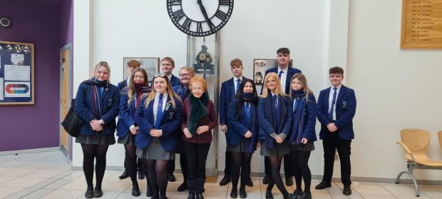 Image of 13 people- At a school with a survivor