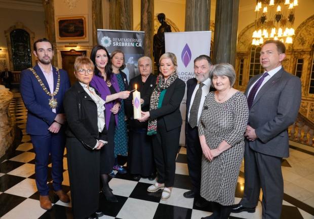 Photograph (from left to right): Lord Mayor of Belfast, Lu Lawrence - daughter of Holocaust survivor Zigi Shipper, dFM Emma Little-Pengelly, Fleur Anderson MP on behalf on the Secretary of State, Munira Subašić - President of the Mothers of Srebrenica, FM Michelle O’Neill, Rabbi David Kale, Shirley Lennon – HMDT, and Paul Lopez-Salzedo – HMDT.