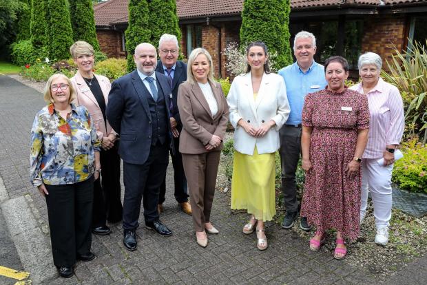 First Minister Michelle O’Neill and deputy First Minister Emma Little-Pengelly are pictured with staff, trustees and volunteers at the Foyle Hospice.